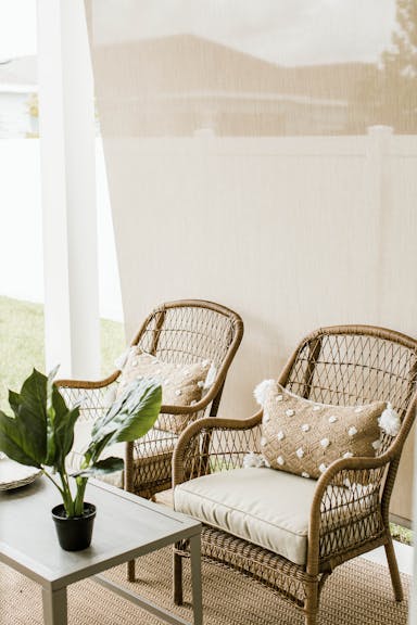 outdoor solar shades and outdoor furniture with small plant on table