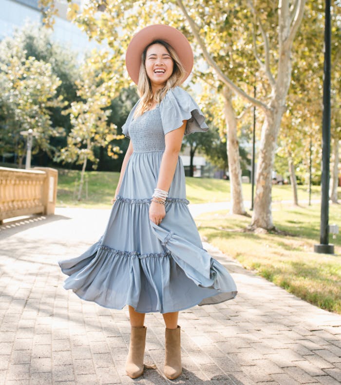 Annie Mescall outside in a pale blue dress.