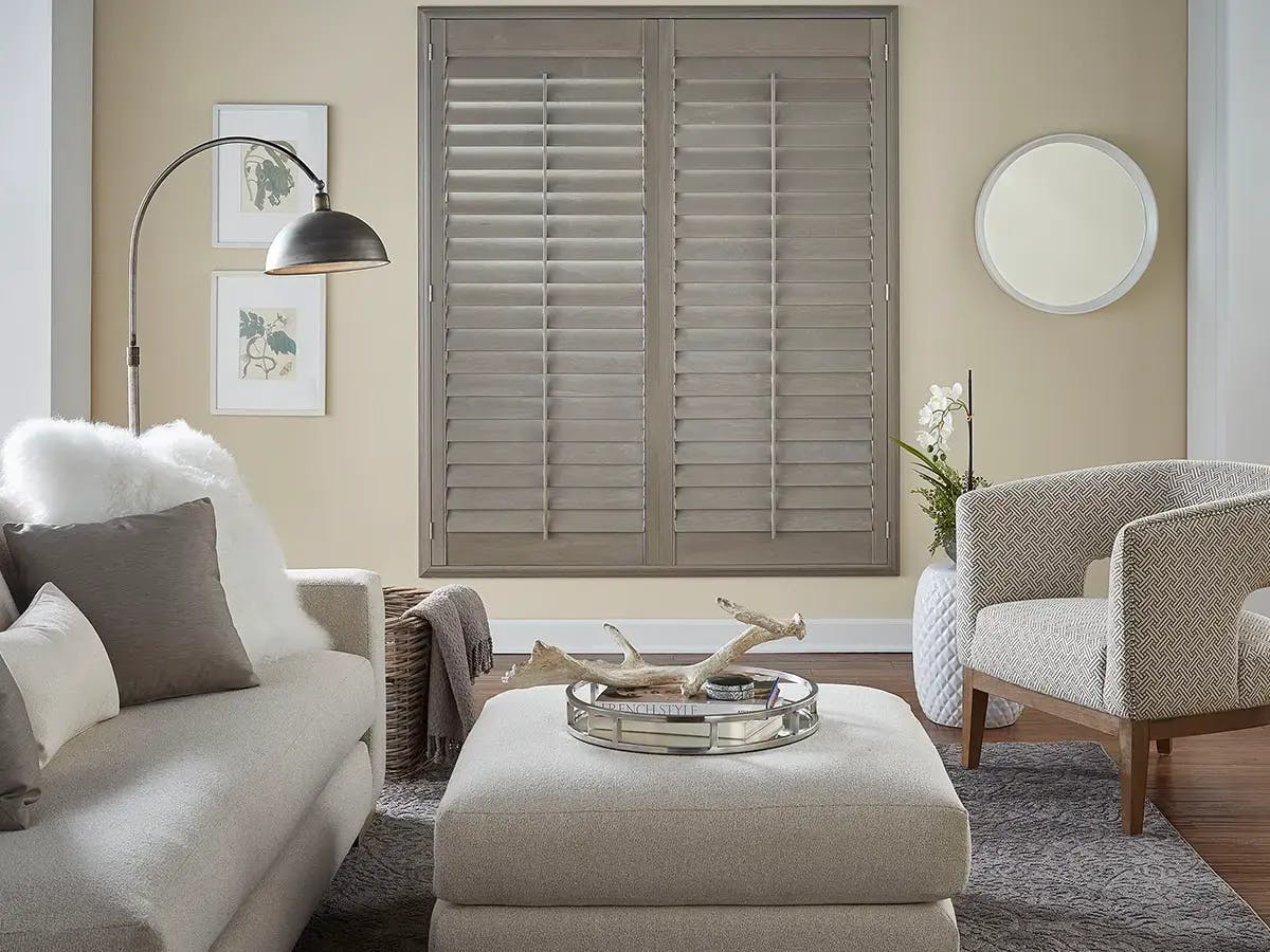 Modern space featuring neutral colored wood shutters.
