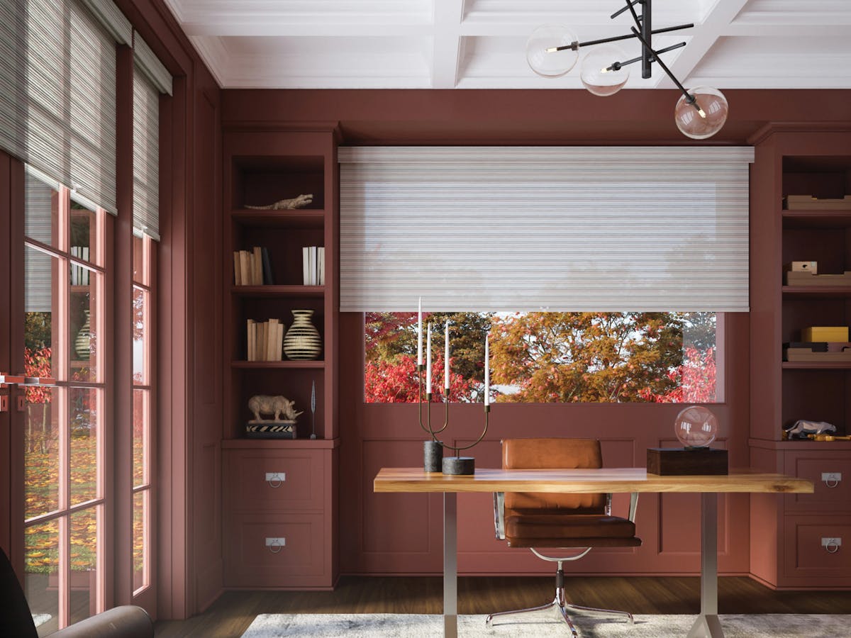 A bedroom with deep purple curtains and gray-toned furniture.