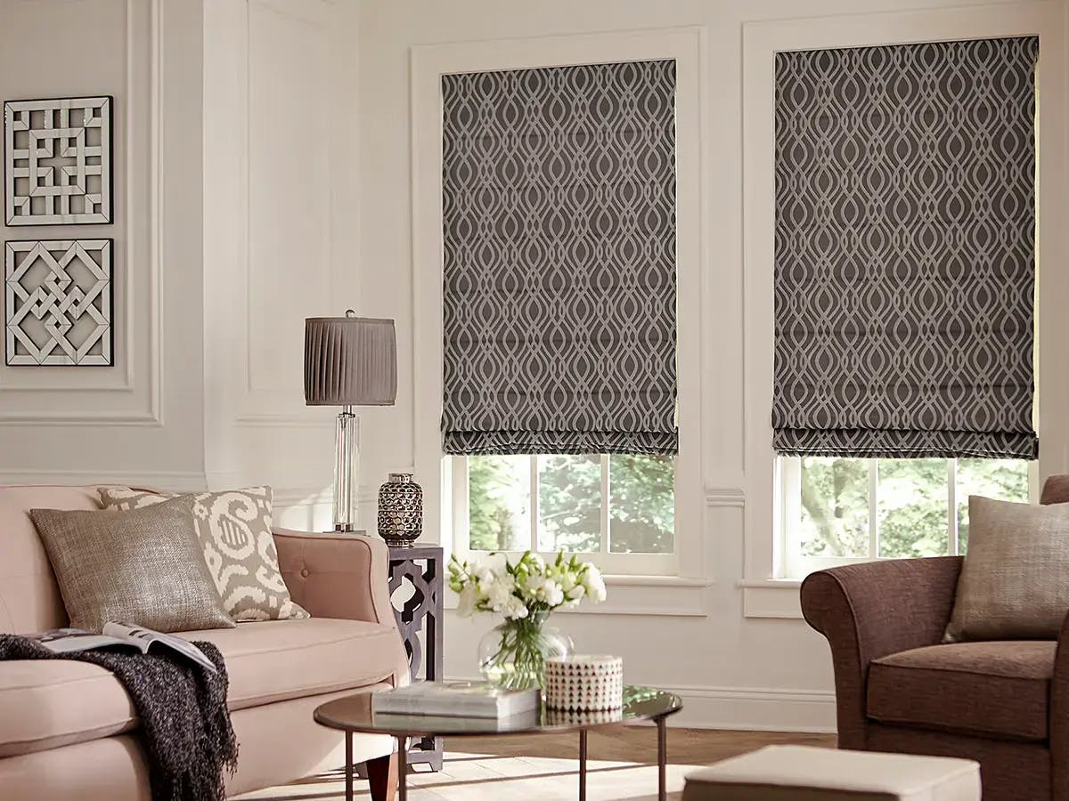 Living room with roman shades and neutral-toned furniture.