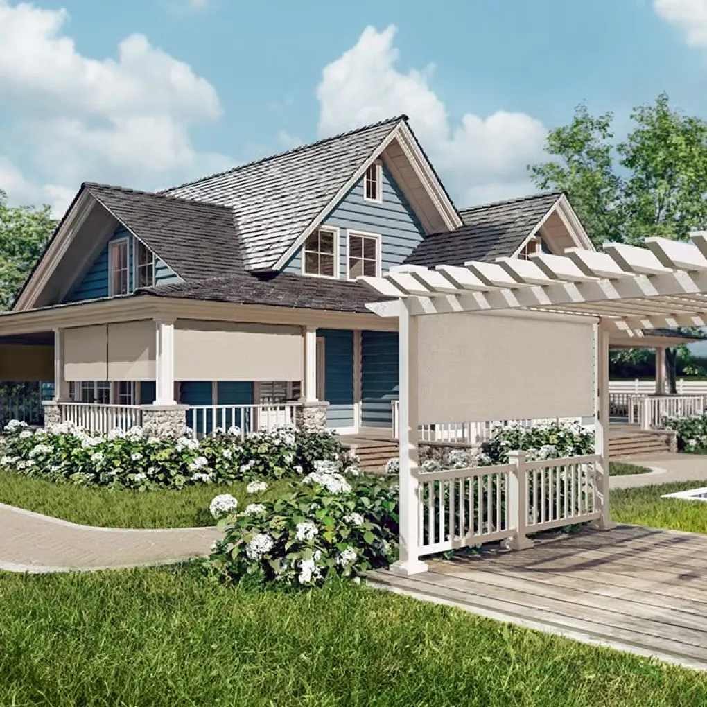 A blue house with white railing and a gray roof. There’s a matching Pergola on the front lawn and light-colored exterior shades hanging from the patio and the pergola.