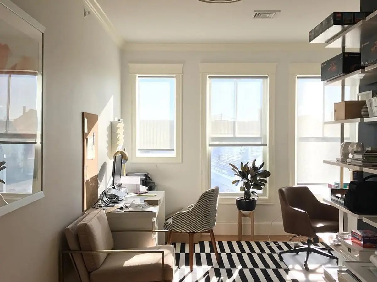 Neutral office space with roller shades.