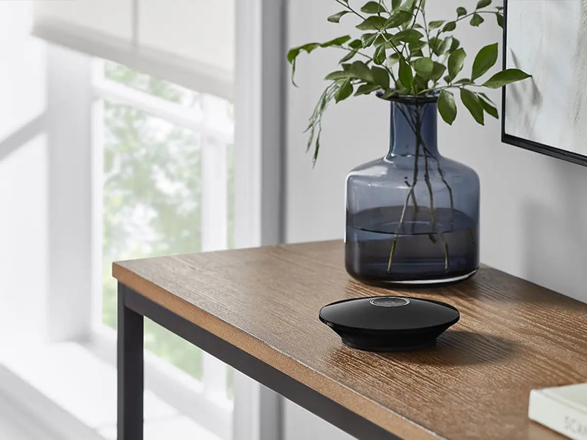 Smart home device placed on a table near a window.