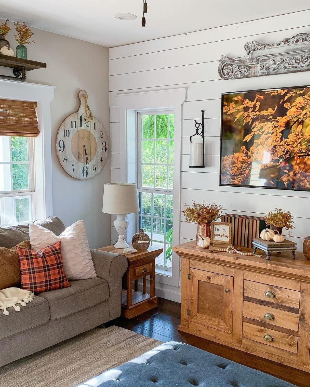 Living room filled with orange, brown and fall-themed decor.
