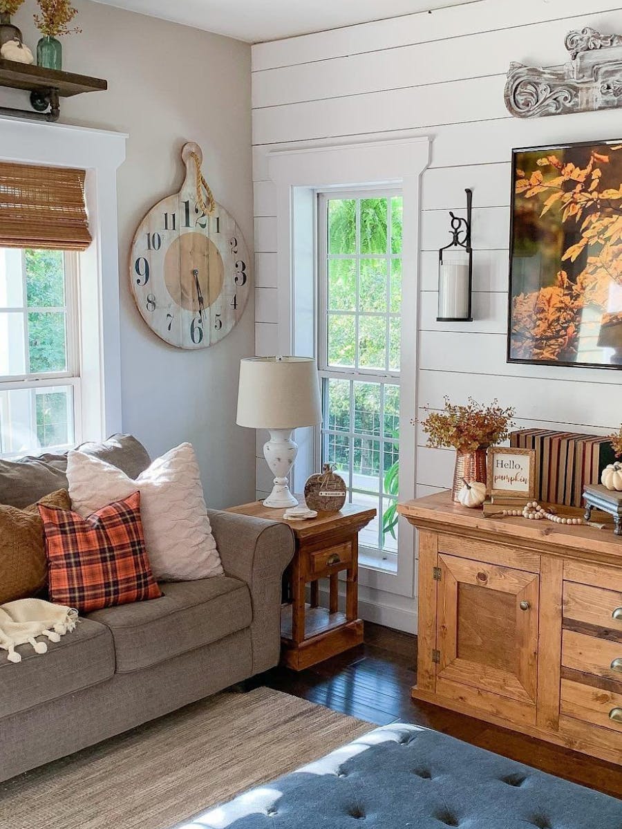 Living room filled with orange, brown and fall-themed decor.