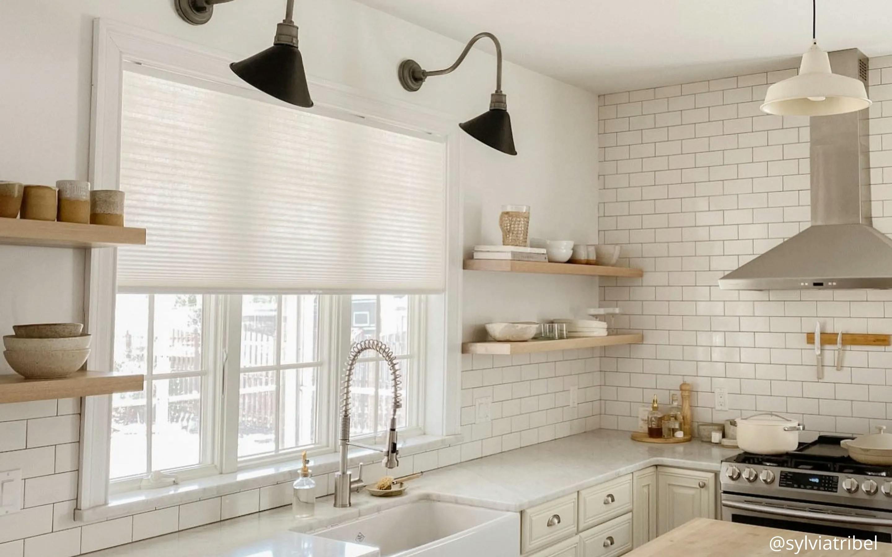 Eco-friendly cellular shades on a window above a kitchen sink.