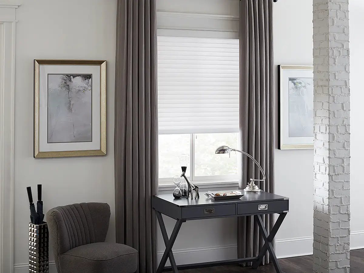 Modern entryway with layered window treatments.