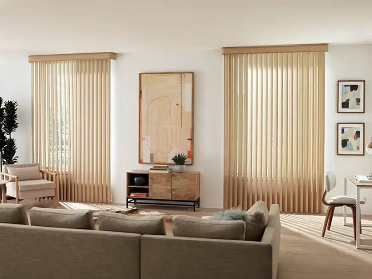 Modern, warm living room with vertical blinds.