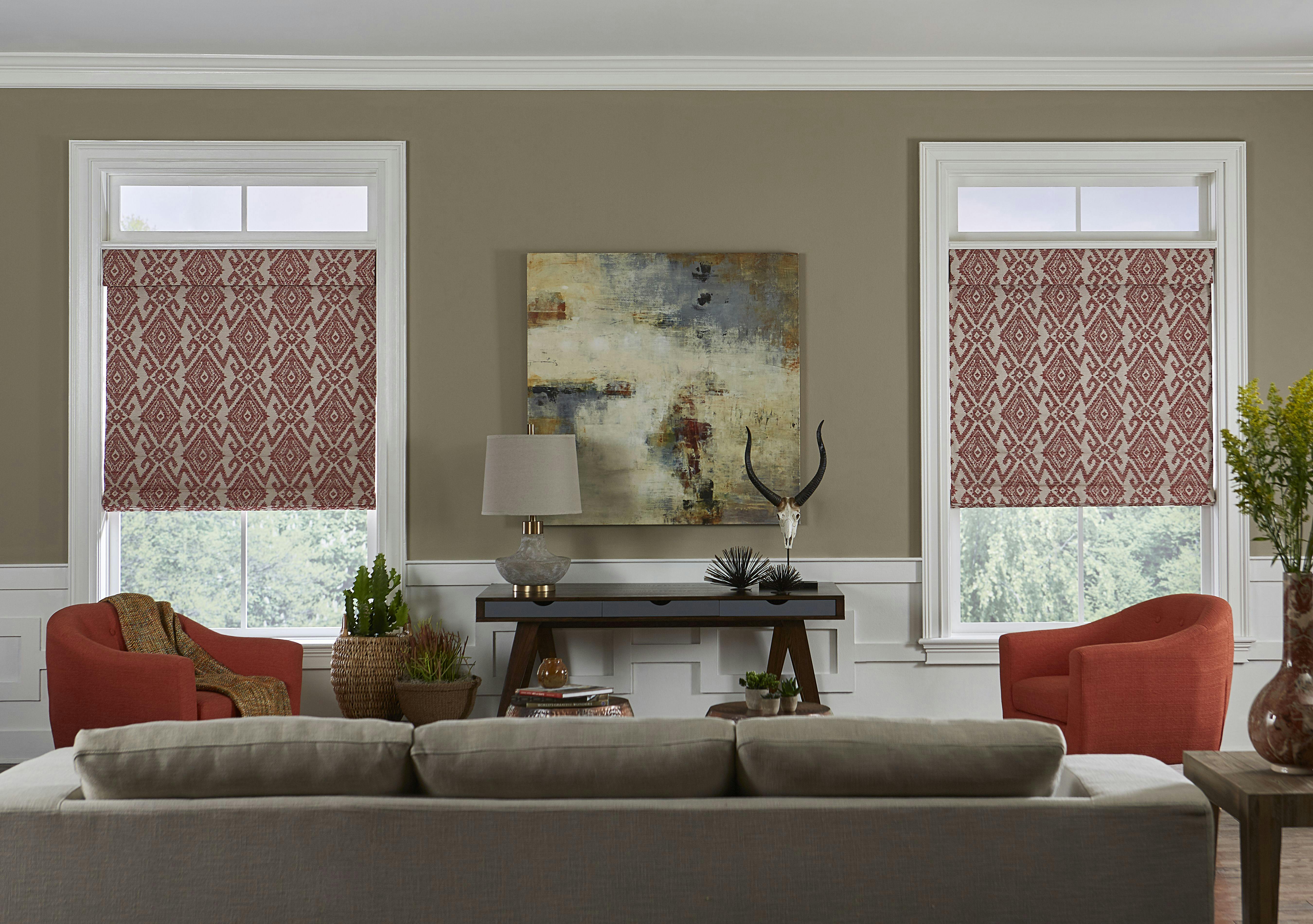 red roman shades in living room couch and desk