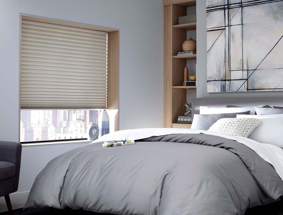 contemporary bedroom with grey comforter and blackout cellular shades