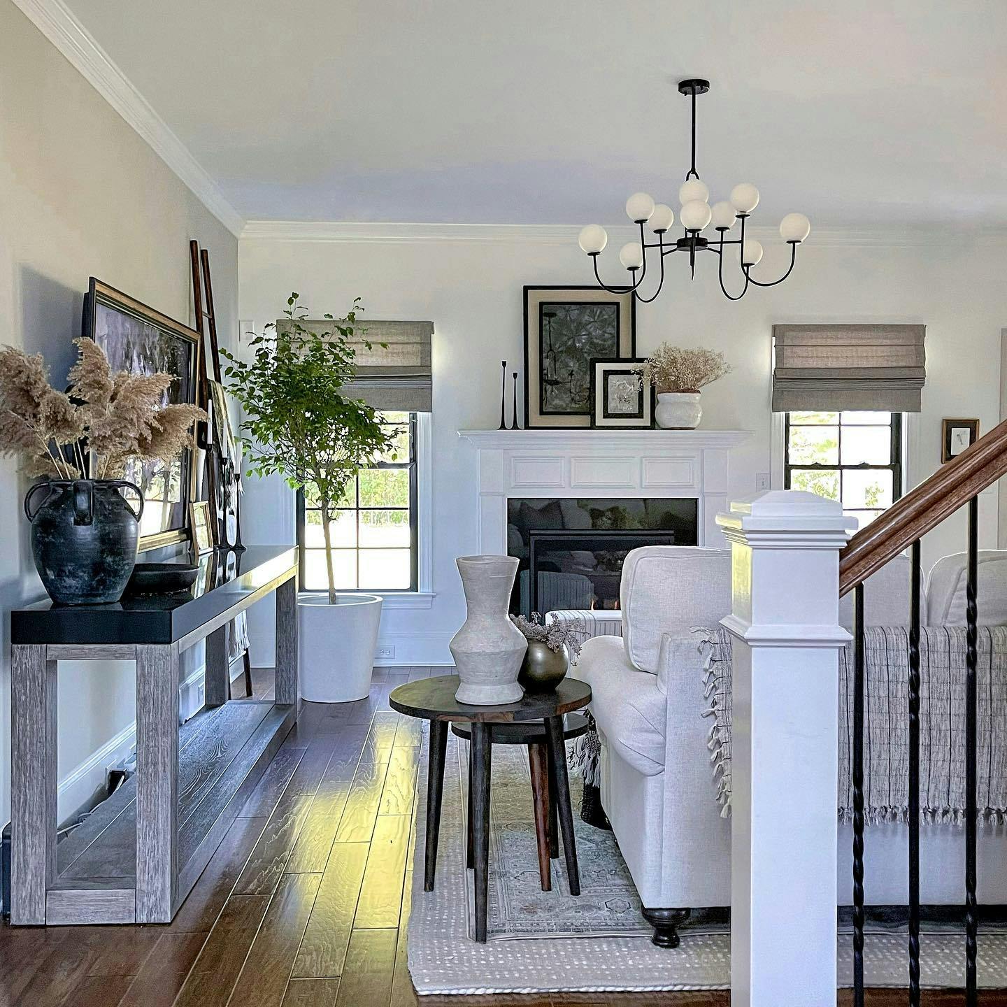 a modern living room with neutral roman shades