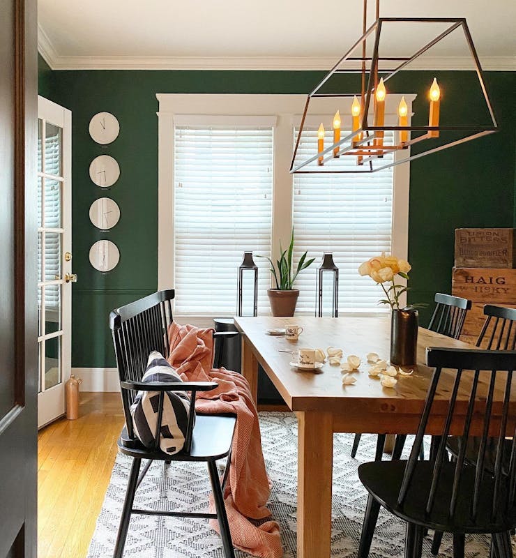 homes for sale. a dining room with green walls with 2 inch faux wood blinds in white from Blinds.com