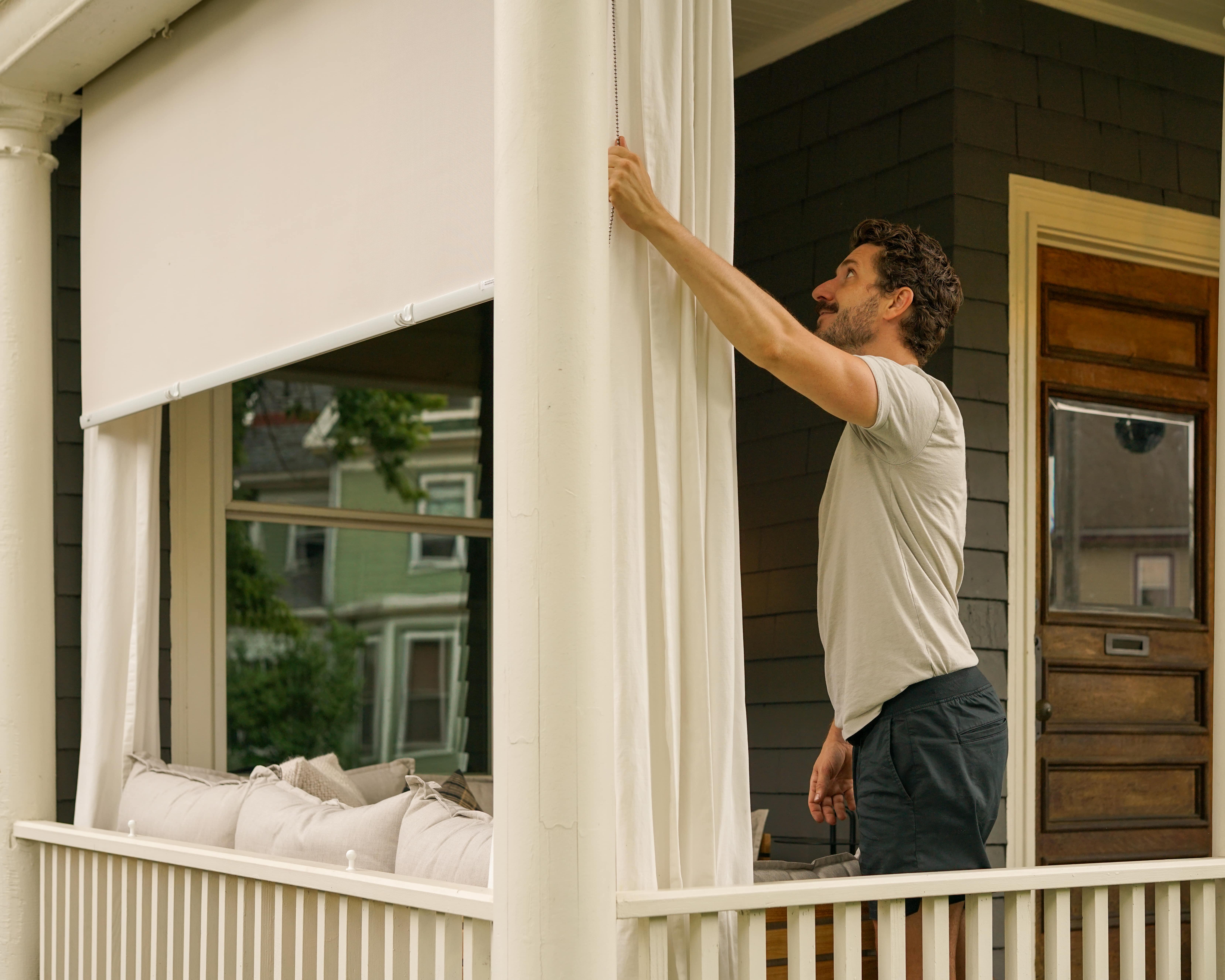 One of the renovation husbands installs their new outdoor solar shades