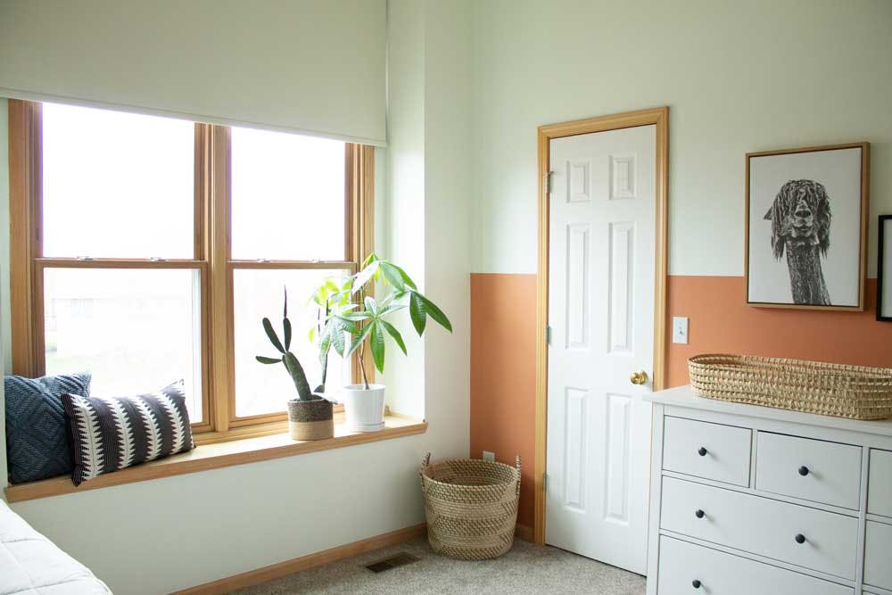 white roller shades over window seat