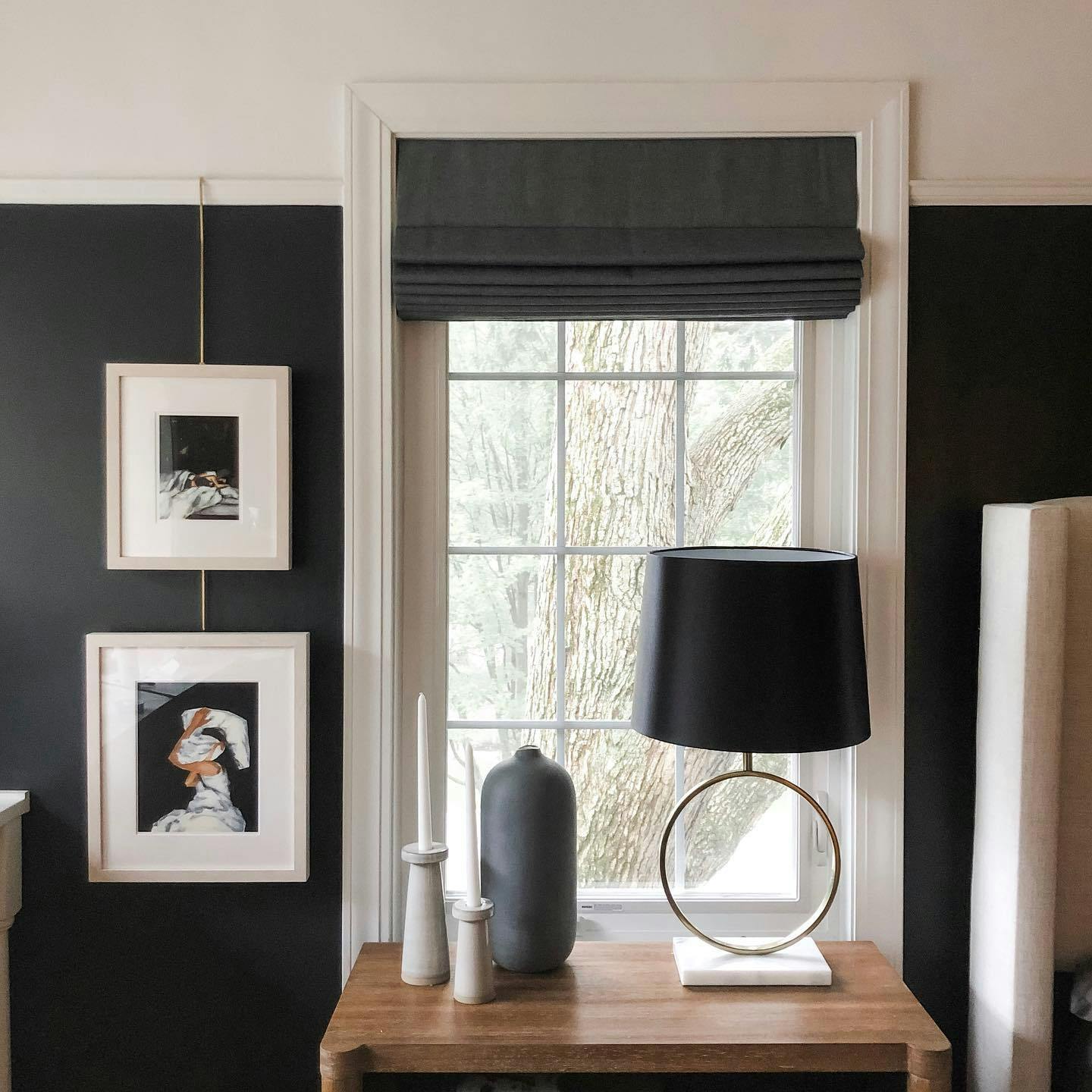 A modern black and white window display with premium roman shades.