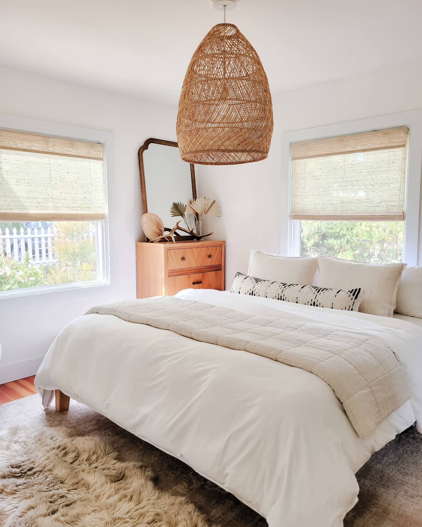 clean bedroom with premium woven wood shades on the windows