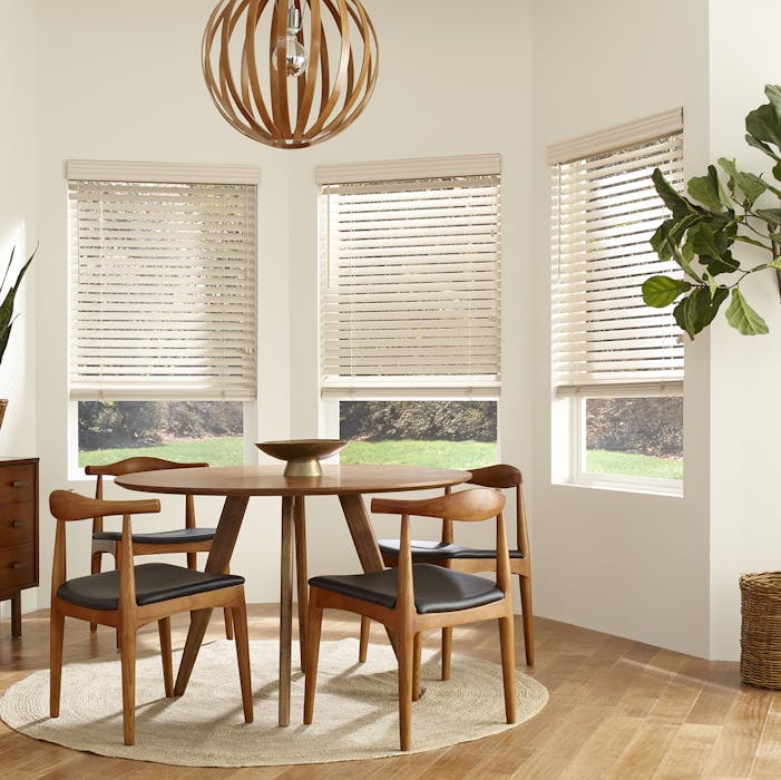 a dining area with bay windows