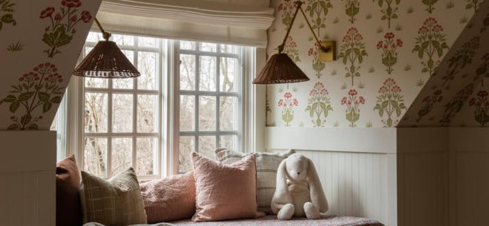 A child's bedroom window with Premium Roman Shades in Gent Bisque from Blinds.com