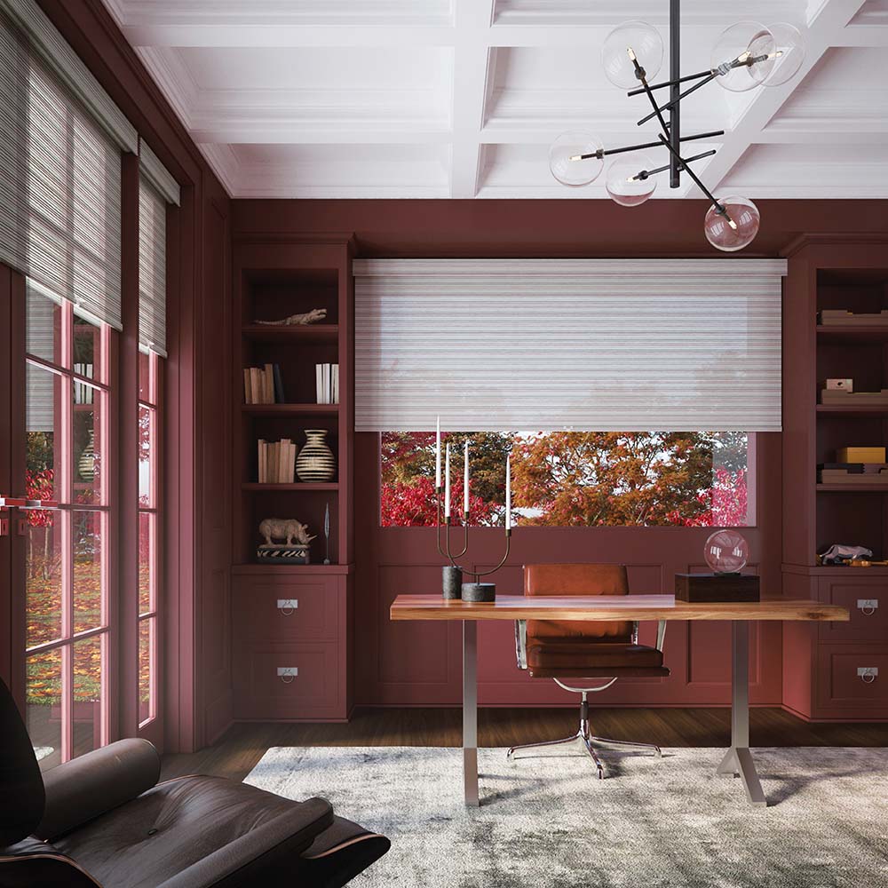 modern office with maroon walls, white roller shades and oak desk.