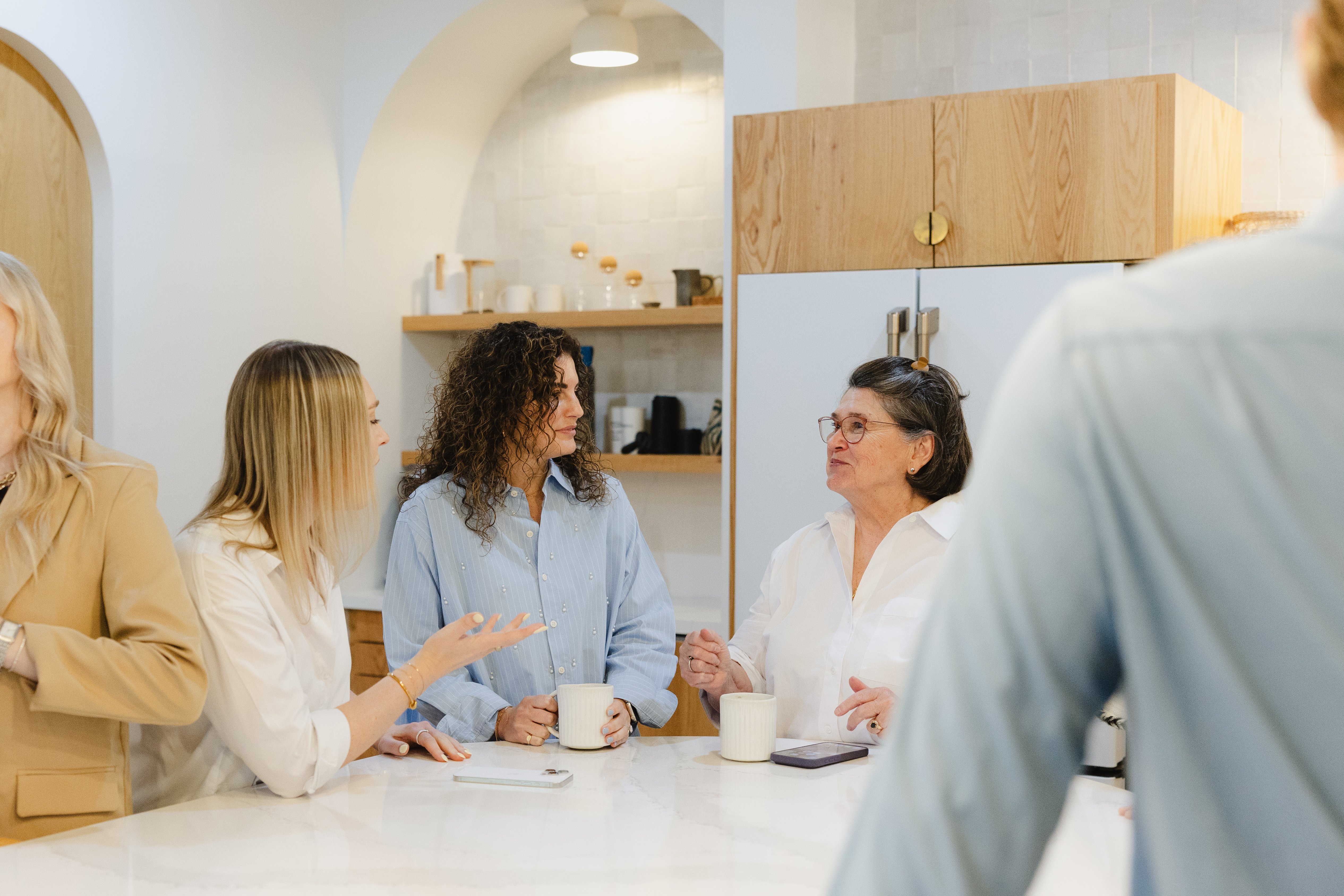 Marketing team collaborating around a table, representing the decision between in-house and agency marketing