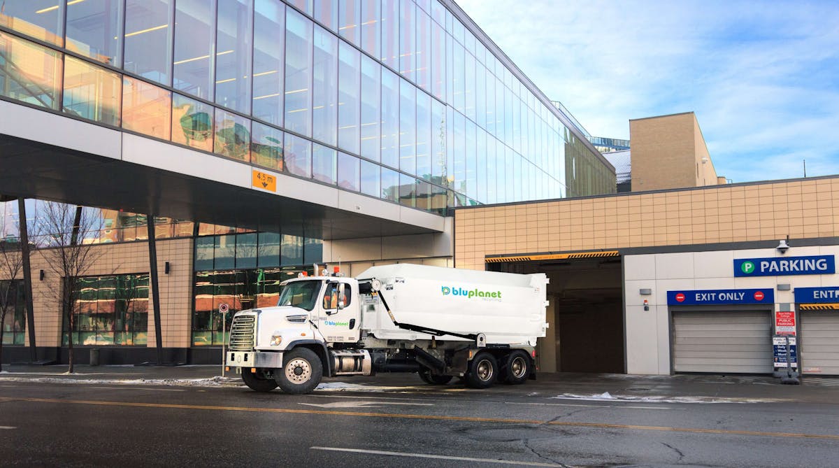 BluPlanet Recycling Truck Carrying Compactor Downtown Calgary