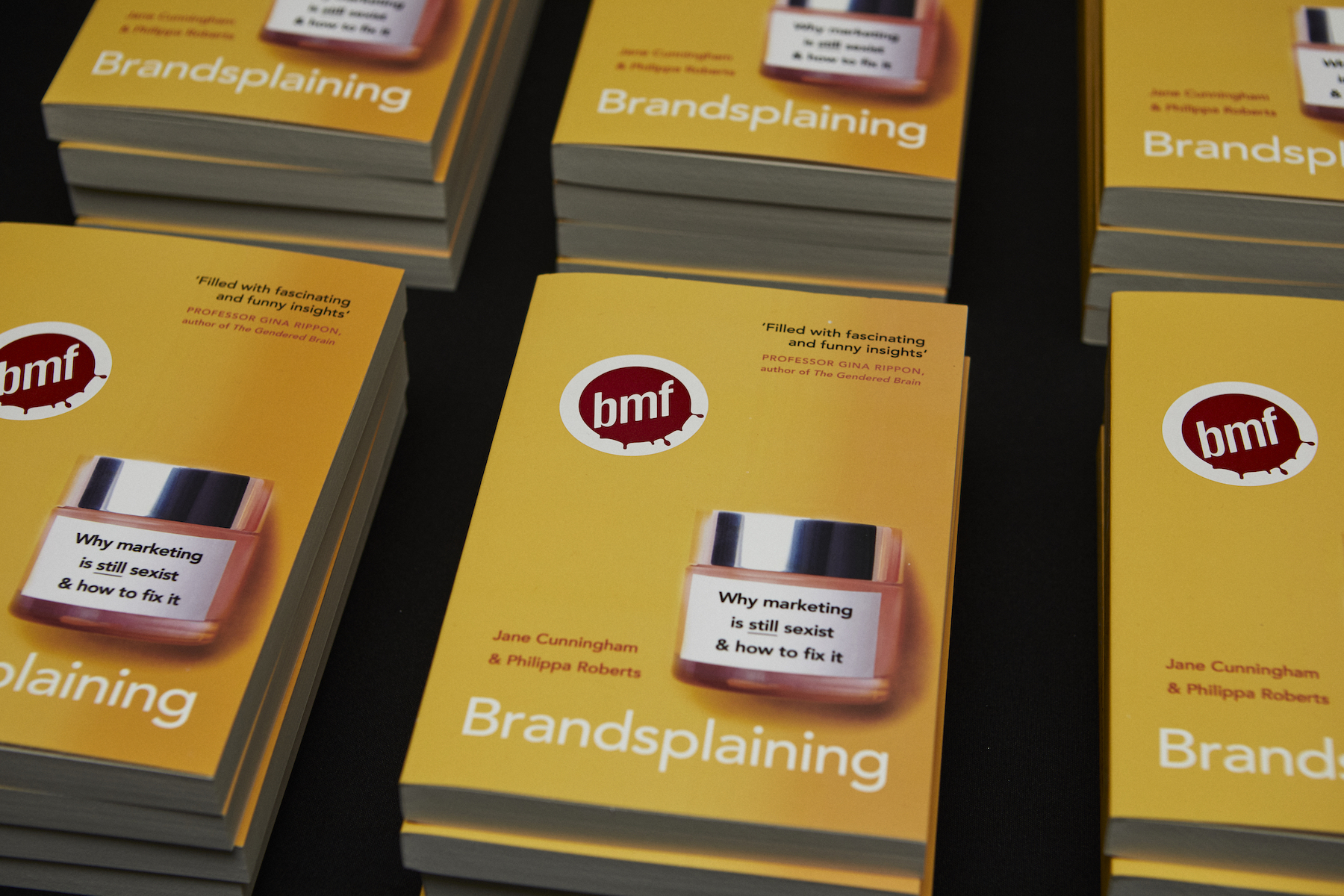 An image of stacked books titled: Brandsplaining".