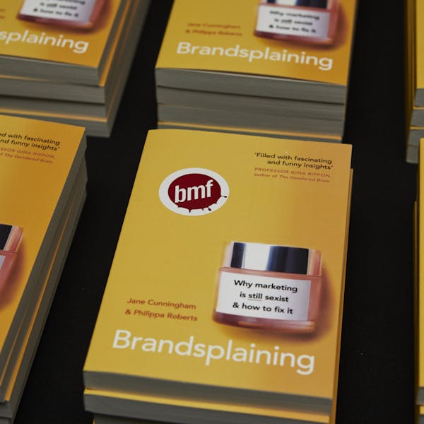 An image of stacked books titled: Brandsplaining".