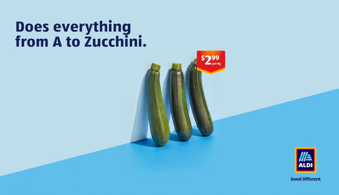 An ALDI advertisement showing three zucchini's leaning against a wall with the tagline: "Does everything from A to Zucchini".