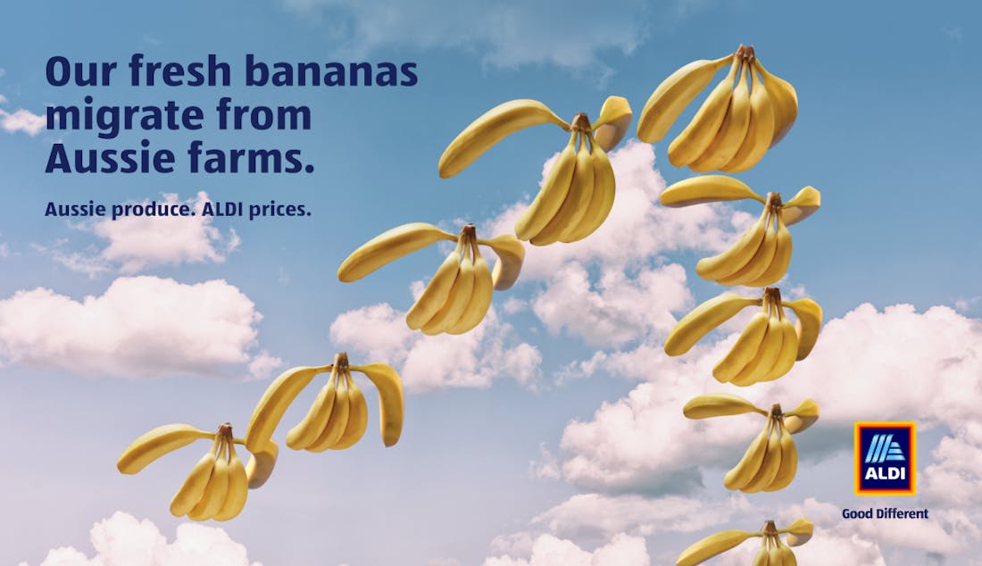 An ALDI advertisement featuring banana bunches soaring like birds with the headline: "Our fresh bananas migrate from Aussie farms".
