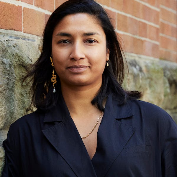 A portrait image of a woman with brown hair.