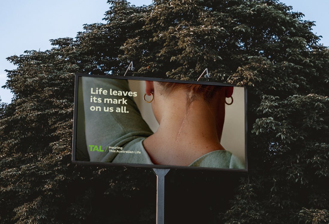 A stunning billboard design showing a scar on the back of a woman's head with the headline: "Life leaves its mark on us all".