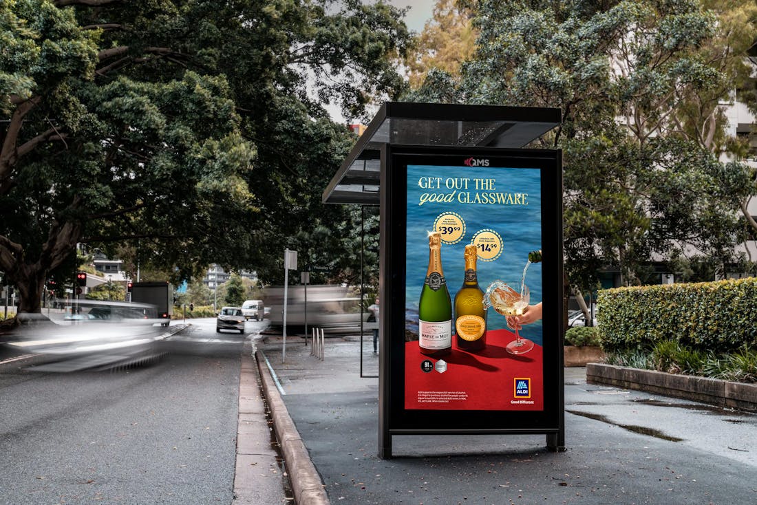 Bus stop billboard advertising sparkling wine.