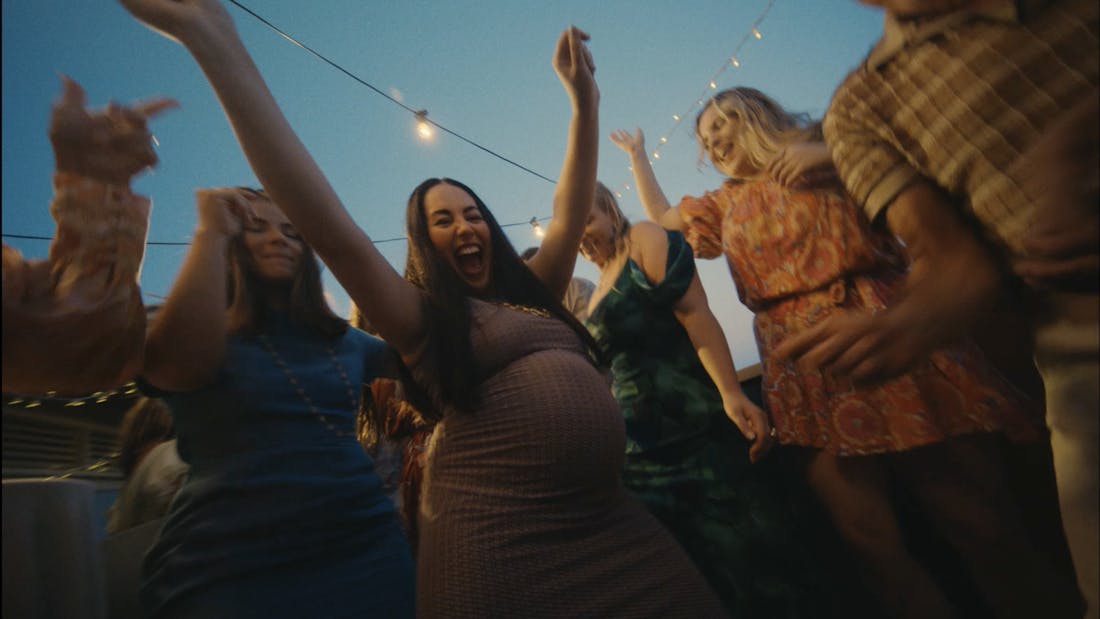 Pregnant woman dancing with friends