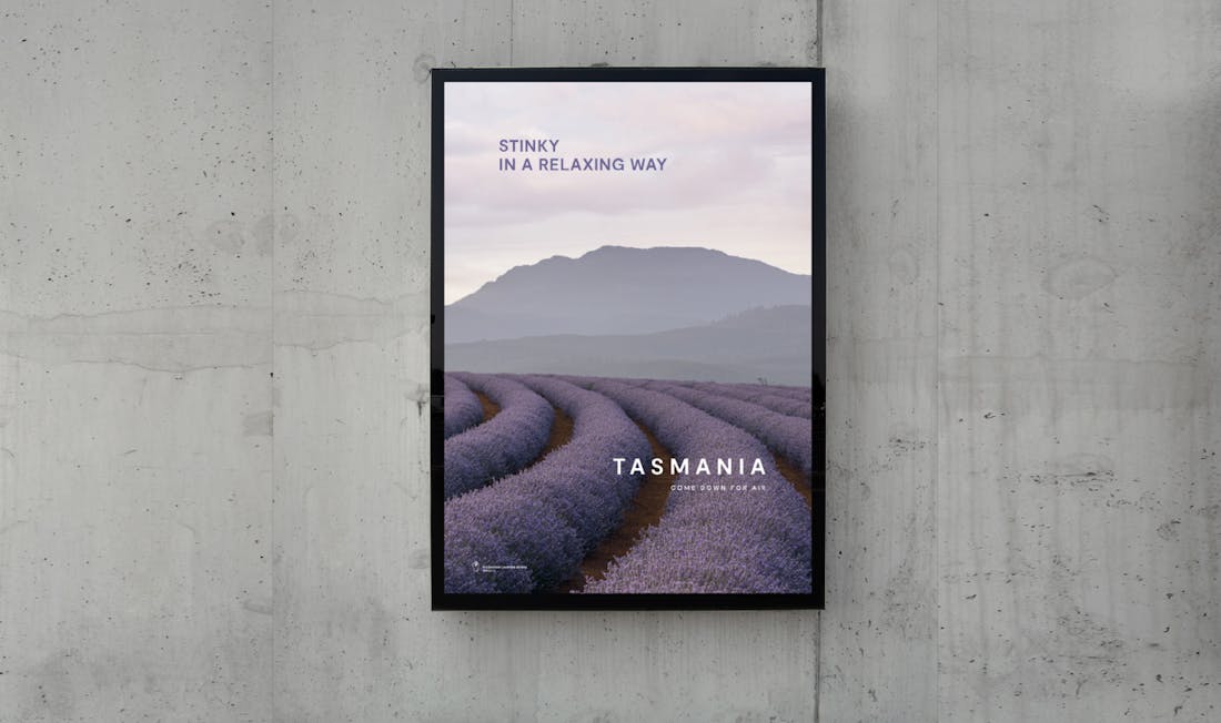 A stunning billboard design containing a landscape image of a field of lavender, a funny headline reads: "Stinky, in a relaxing way".