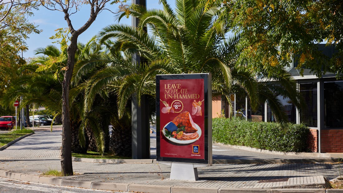 A billboard ad for ALDI featuring an image of a ham with the tagline: "Leave no plate un-hammed".