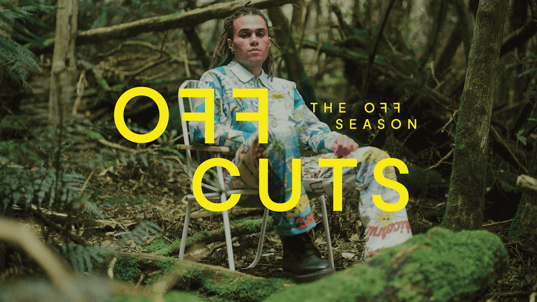 An image of a man sitting on a chair in a rainforest wearing a vibrant jacket from the Off Cuts collection.