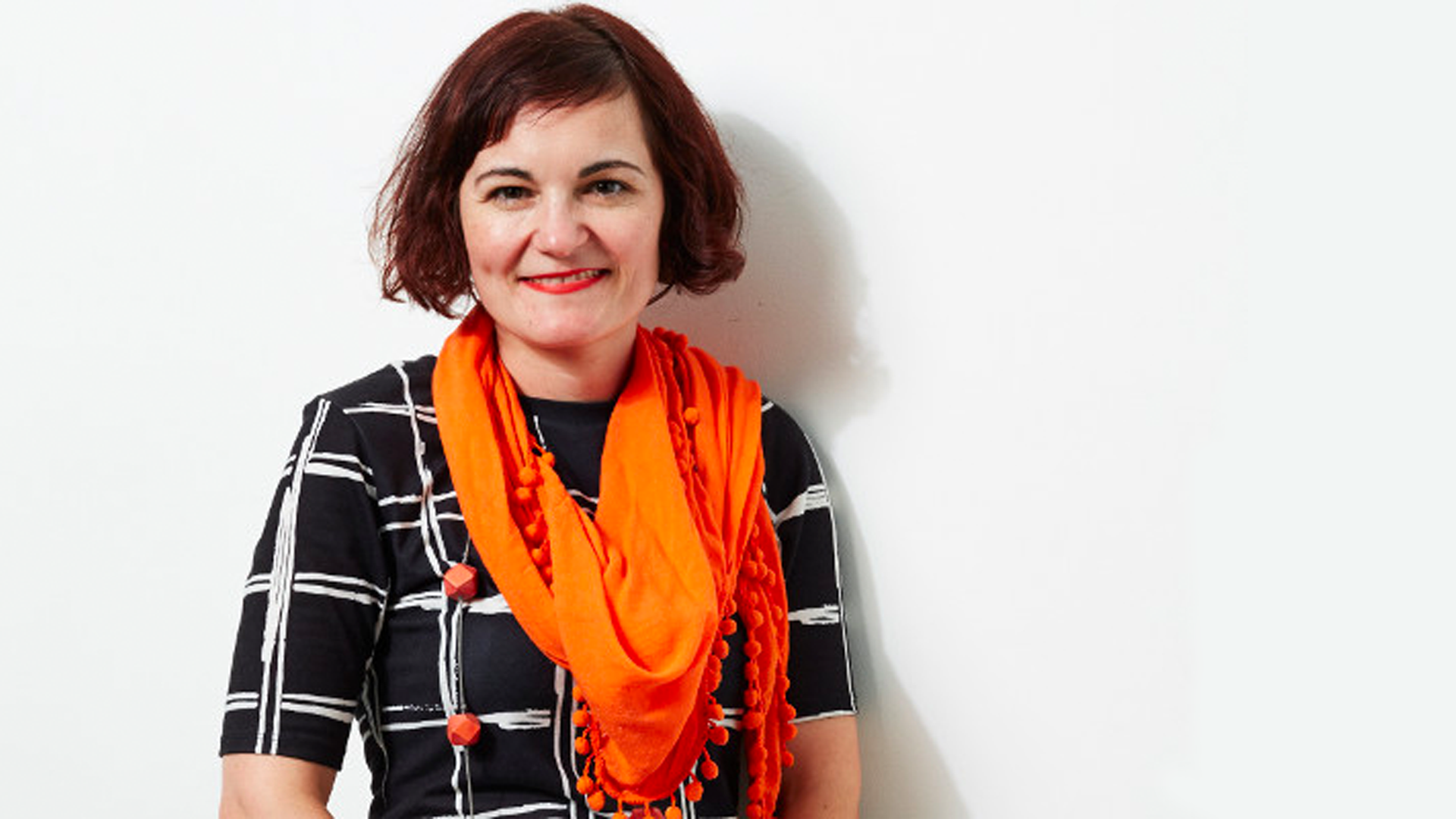 A portrait image of a woman with a cheerful expression.