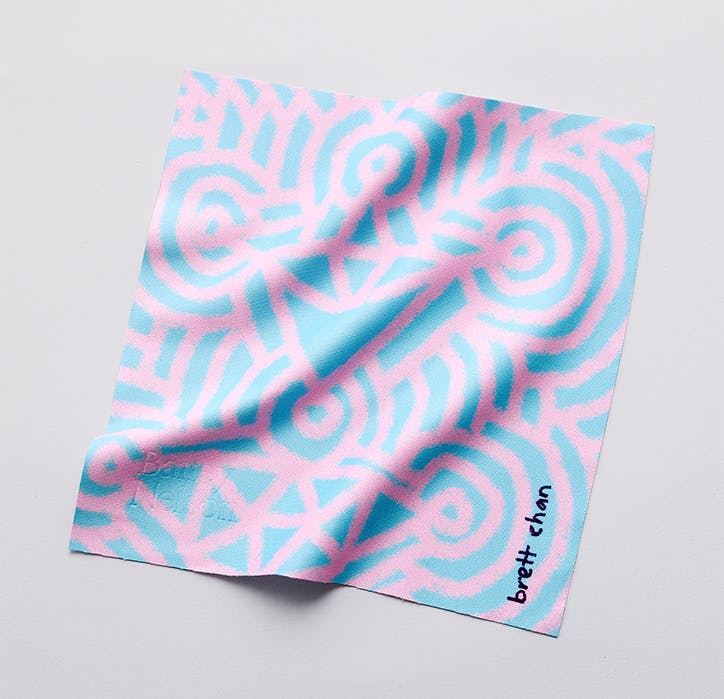 A geometric print pink and blue lens cloth designed by Brett Chan