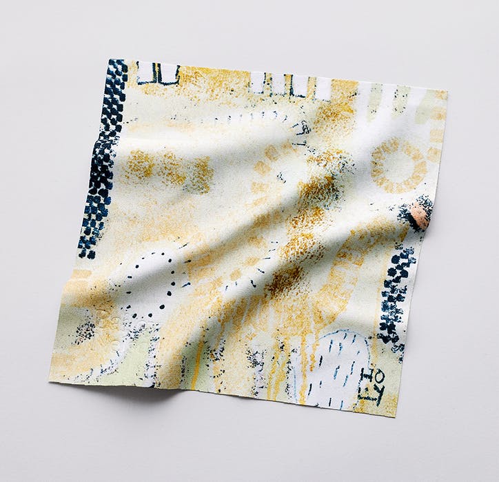 An abstract print beige, black and white lens cloth designed by Holly Terry.