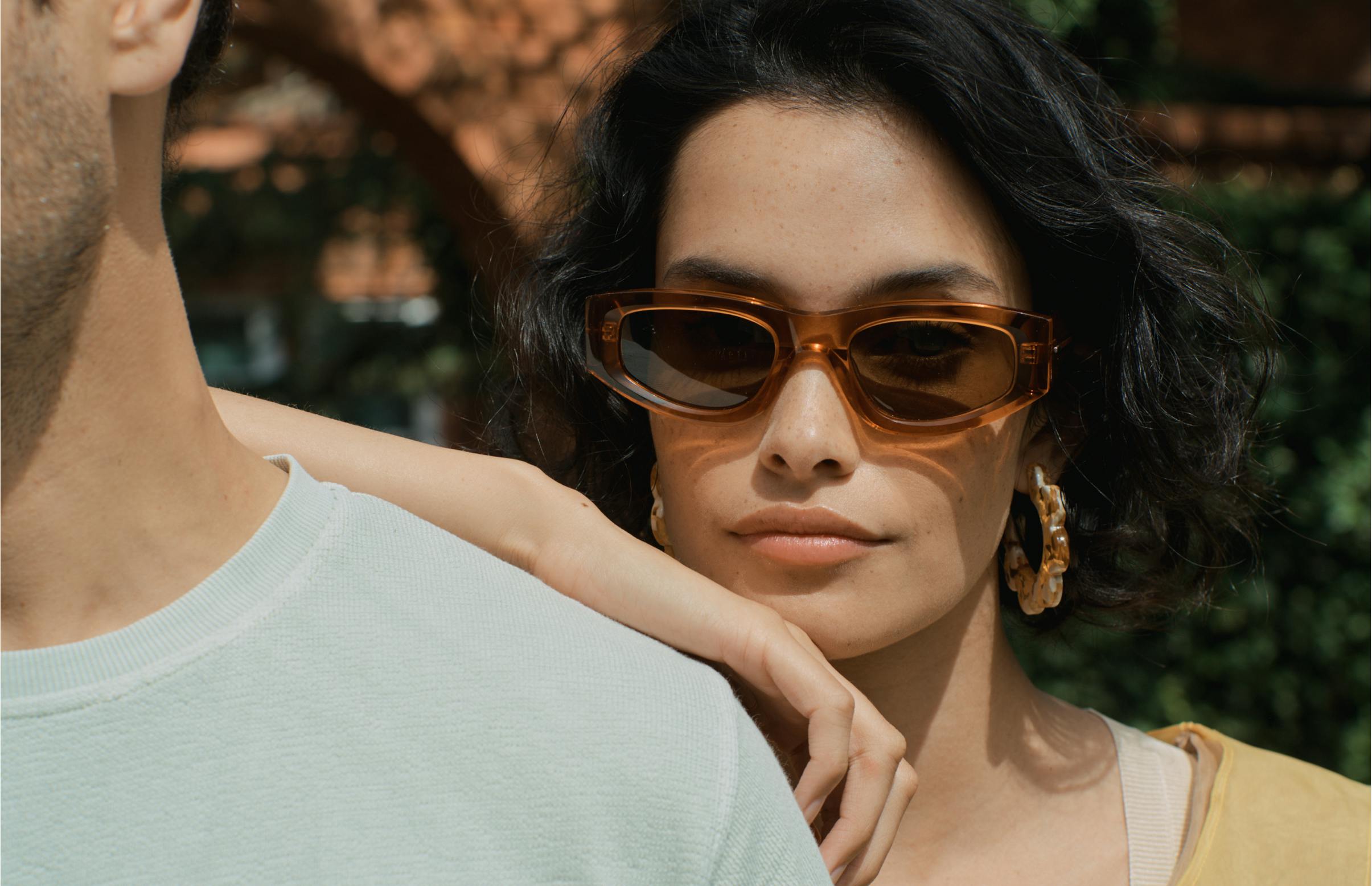 Woman leaning against man's shoulder wearing Gartner sunglasses