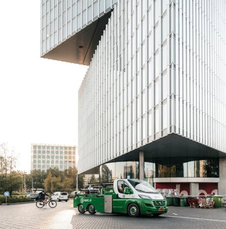 Bnext.nl wagen voor een kantoorgebouw in een stad
