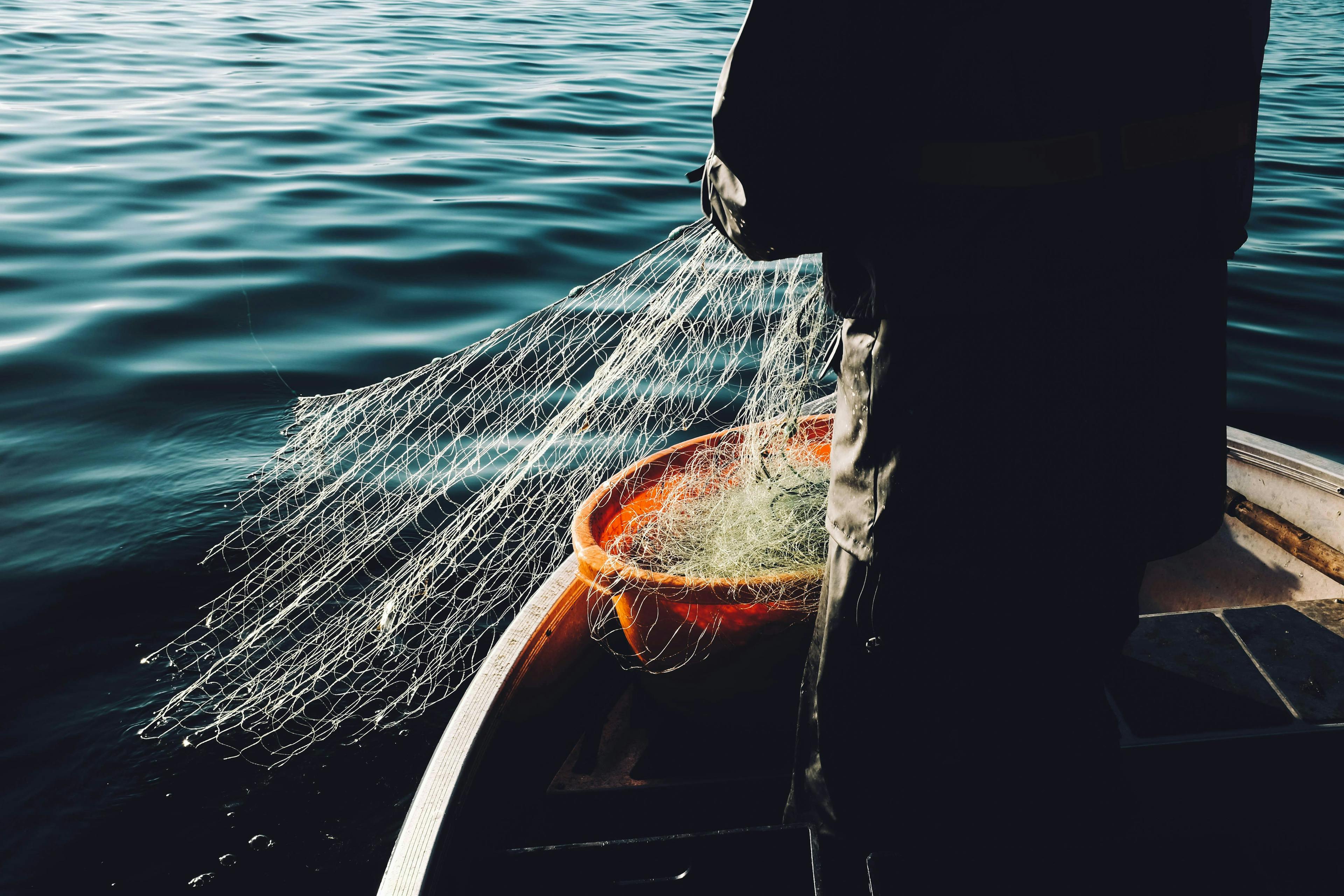 fisher use fishing net on the fishing boat. The Complete Guide to Fishing Boat Costs