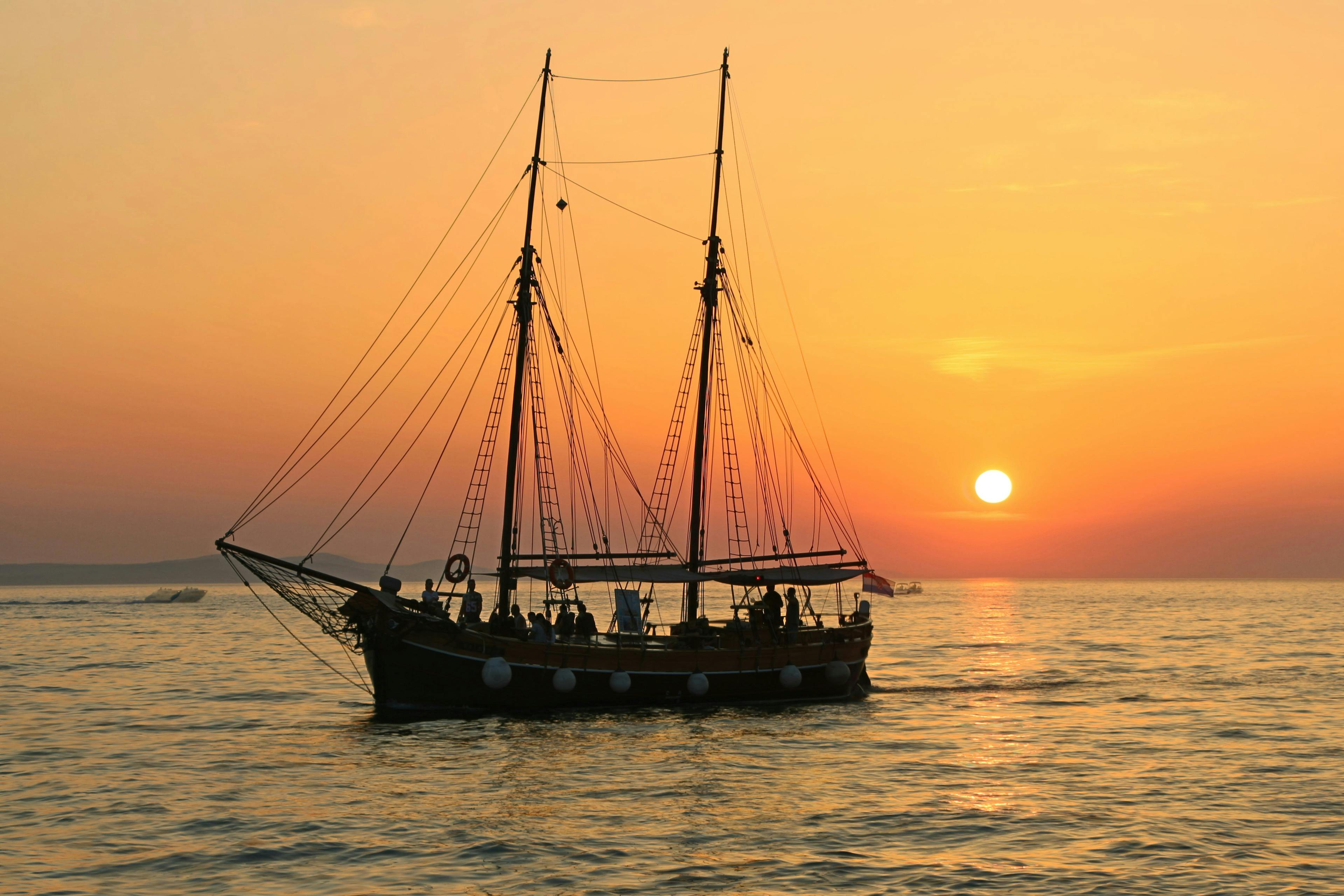 big boat during beautiful sunset in an open sea. Navigating the Waters of Boat Shipping: What It Costs and How to Save