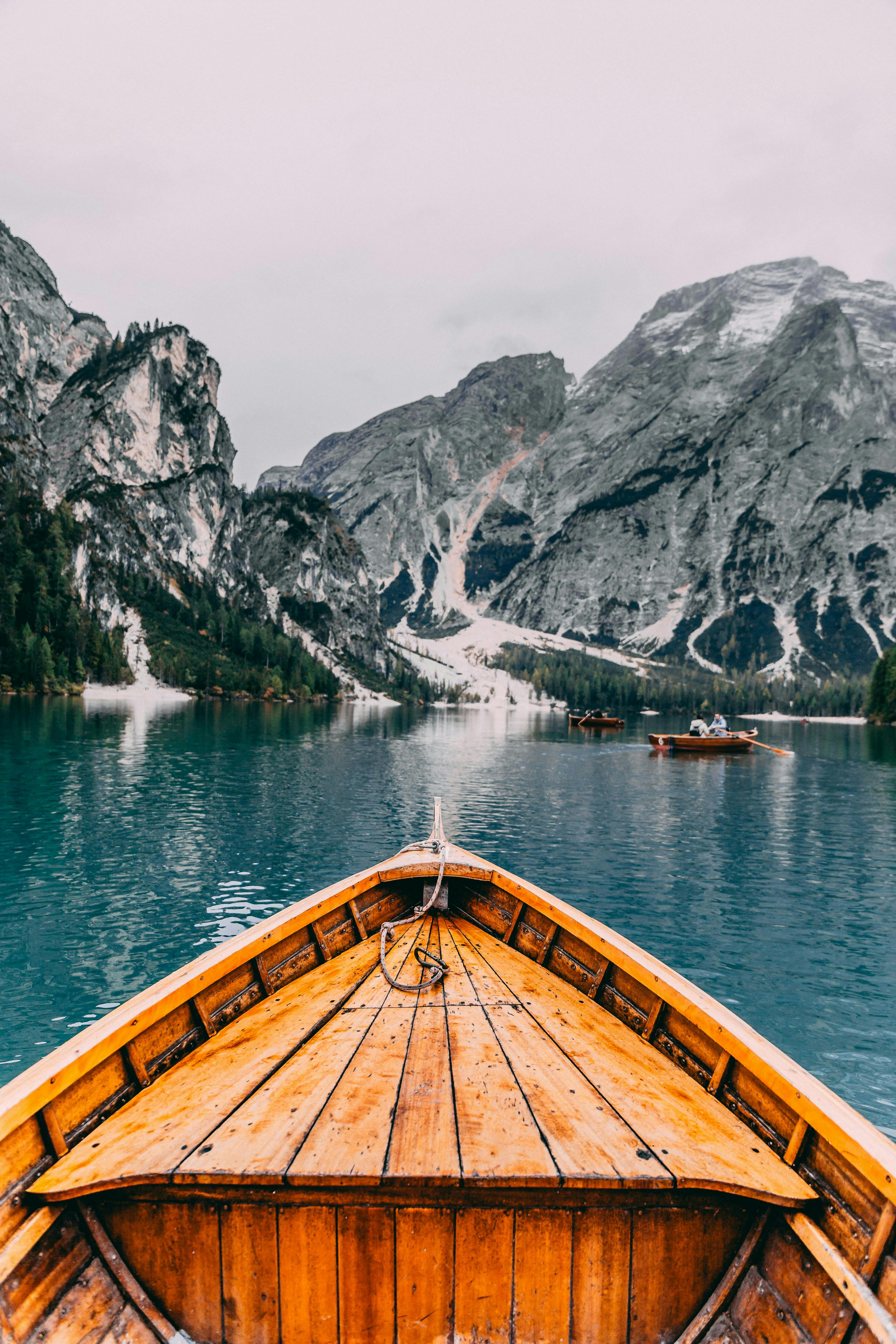 boat is floating in the glacier river with the mountain view.  Navigating the Costs: Understanding Boat Transport Prices Per Mile