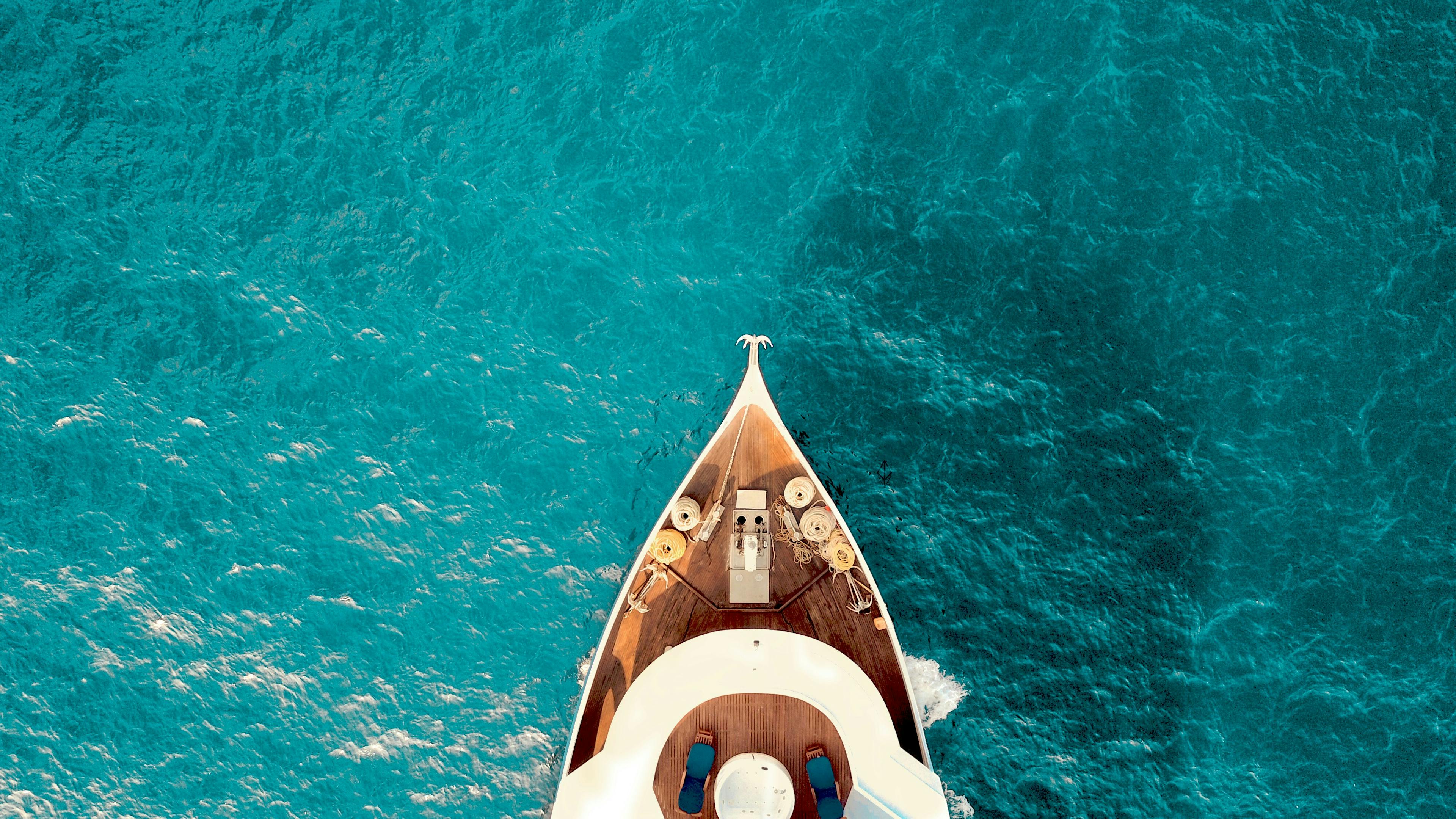 crystal blue ocean water and the white yacht