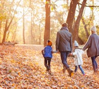 family walking at sunset during fall