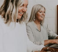 Two women working together