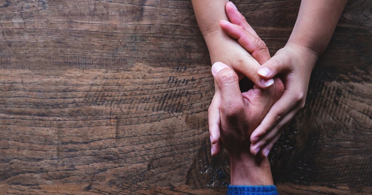 Two people holding hands