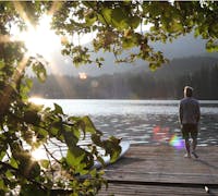 man walking on a dock at sunrise